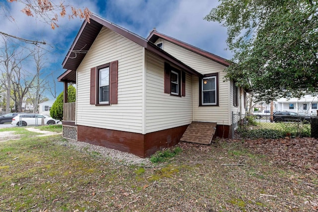view of home's exterior with fence