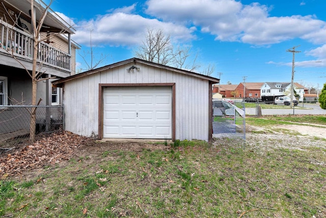 detached garage featuring fence