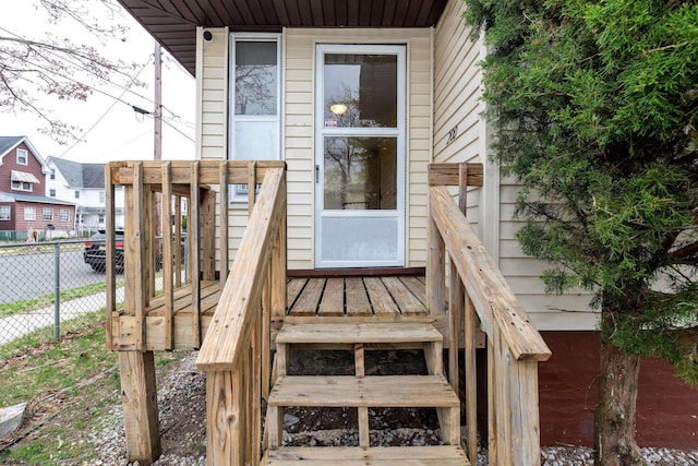 view of exterior entry featuring fence