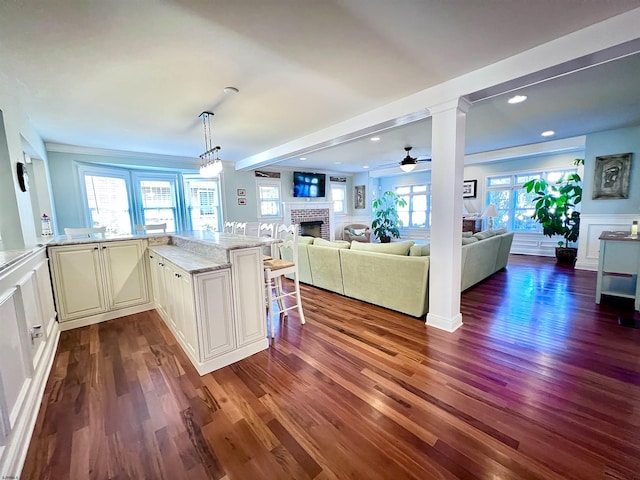 22 Spruce Rd, Ocean City, NJ 08226 - kitchen featuring a fireplace, dark wood-style flooring, light stone counters, ceiling fan, and recessed lighting