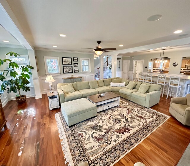 22 Spruce Rd, Ocean City, NJ 08226 - living room featuring crown molding, dark wood-style flooring, a ceiling fan, decorative columns, and wainscoting
