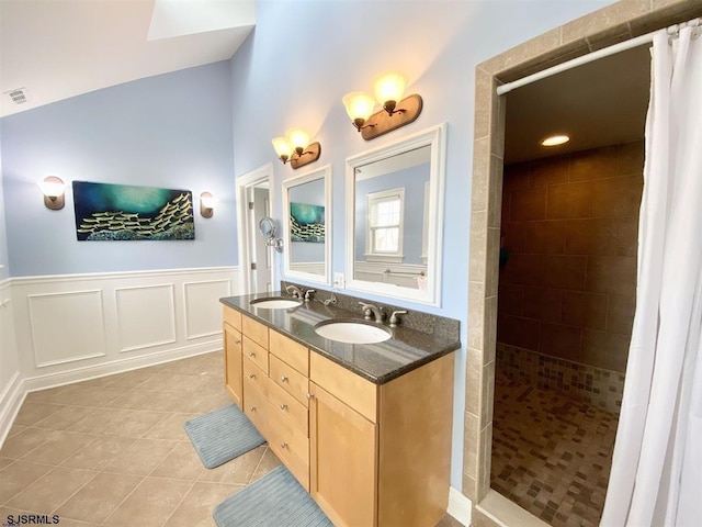 22 Spruce Rd, Ocean City, NJ 08226 - bathroom featuring tile patterned floors, a tile shower, a wainscoted wall, double vanity, and lofted ceiling