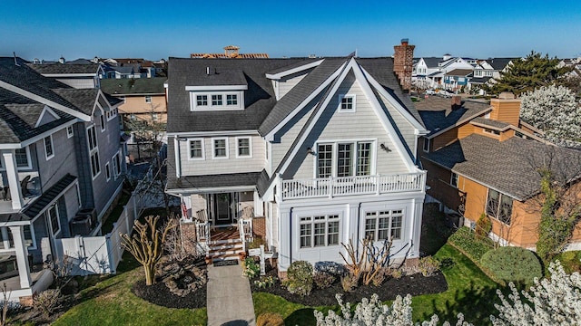 22 Spruce Rd, Ocean City, NJ 08226 - view of front of house with a residential view, fence, a shingled roof, and a balcony