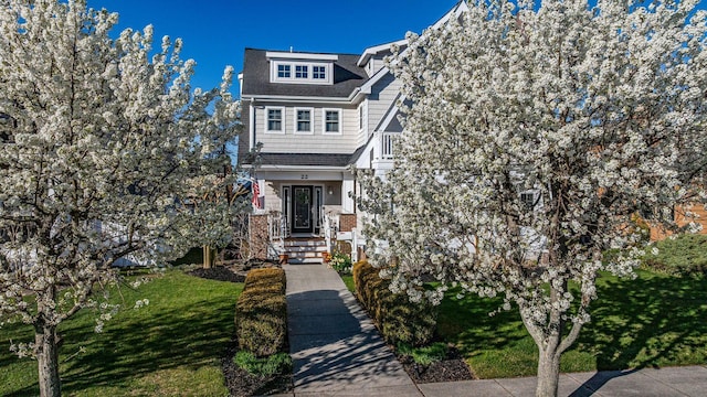 22 Spruce Rd, Ocean City, NJ 08226 - view of front of house with a front yard and roof with shingles