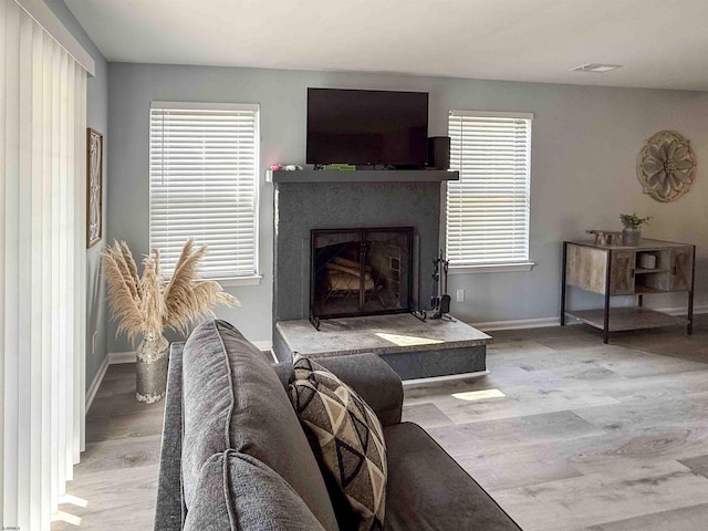 722 Fishers Creek Rd, Galloway Township, NJ 08205 - living area featuring visible vents, baseboards, a fireplace with raised hearth, and wood finished floors
