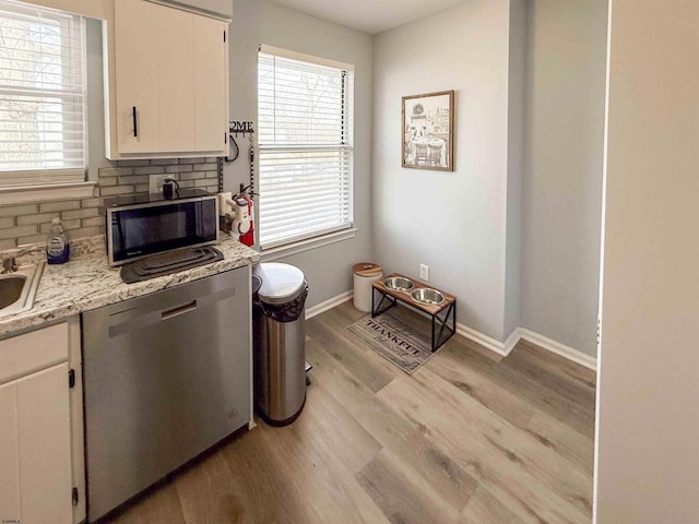 722 Fishers Creek Rd, Galloway Township, NJ 08205 - kitchen featuring tasteful backsplash, black microwave, white cabinets, light wood-style floors, and stainless steel dishwasher