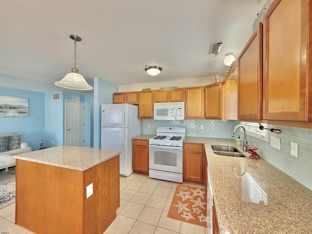 kitchen with white appliances, light tile patterned floors, backsplash, visible vents, and a sink