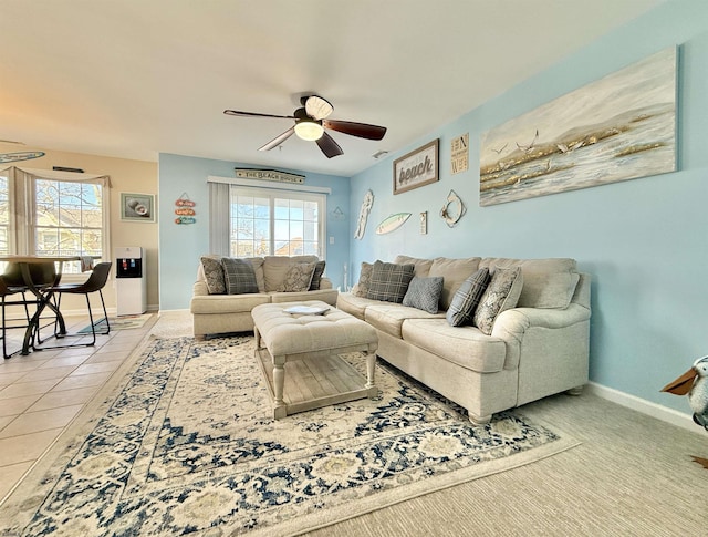 living room with baseboards and a ceiling fan