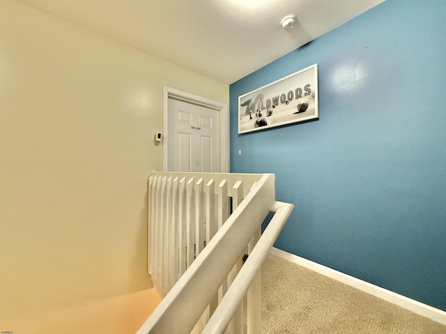 corridor with baseboards and carpet floors
