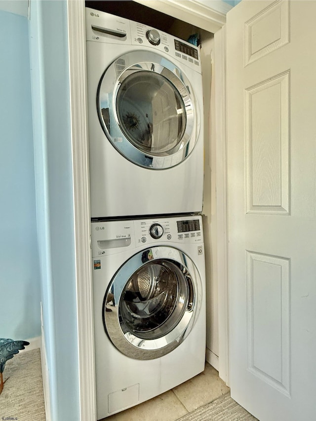 laundry area with stacked washer / dryer and laundry area