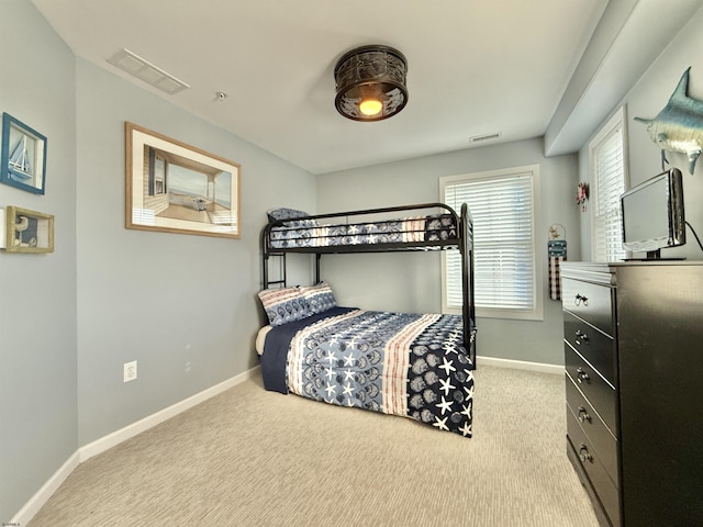 carpeted bedroom with visible vents and baseboards