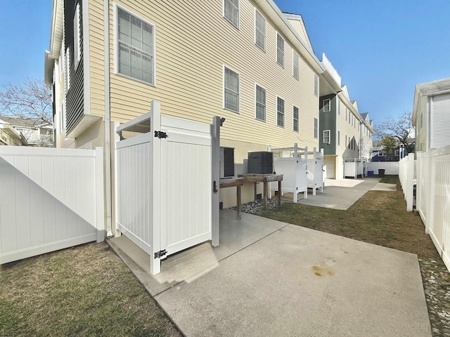 rear view of house with a patio area and a fenced backyard