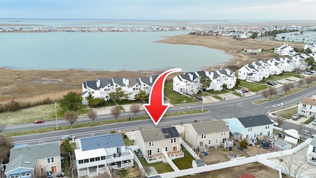 birds eye view of property with a water view and a residential view