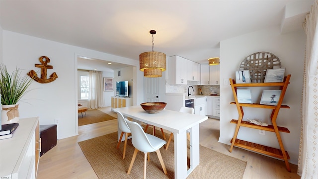 dining space with light wood-type flooring