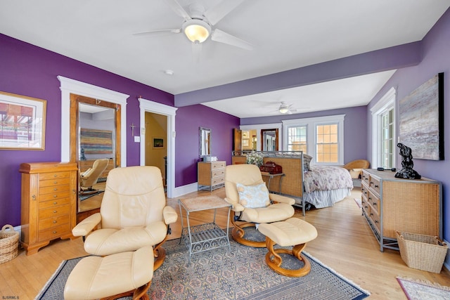 bedroom with light wood-style flooring, baseboards, and ceiling fan