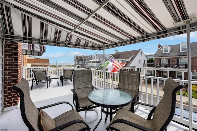 view of patio with a residential view and a balcony