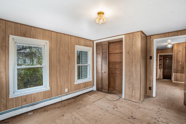 611-615 S New York Rd, Galloway Township, NJ 08205 - unfurnished bedroom with a baseboard heating unit, a closet, and wooden walls