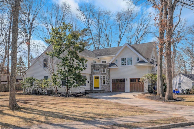 209 Belhaven Ave, Linwood, NJ 08221 - view of front of house featuring stone siding, an attached garage, and concrete driveway