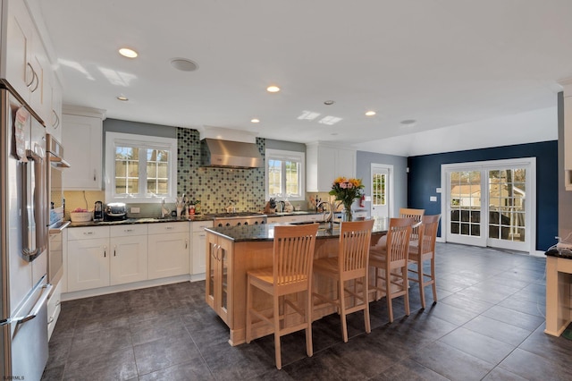 209 Belhaven Ave, Linwood, NJ 08221 - kitchen with wall chimney range hood, tasteful backsplash, recessed lighting, white cabinets, and a kitchen island with sink
