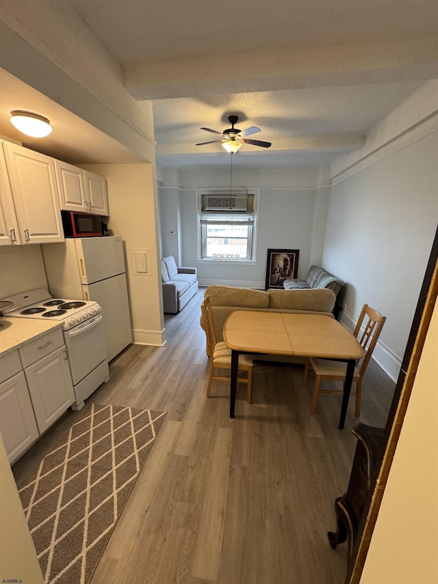 dining area with baseboards, a ceiling fan, and wood finished floors