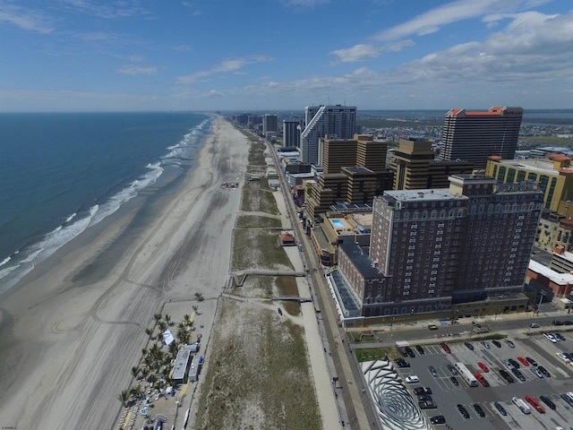 bird's eye view featuring a water view, a view of city, and a view of the beach