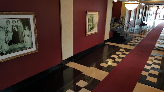 hallway featuring tile patterned floors and stairs