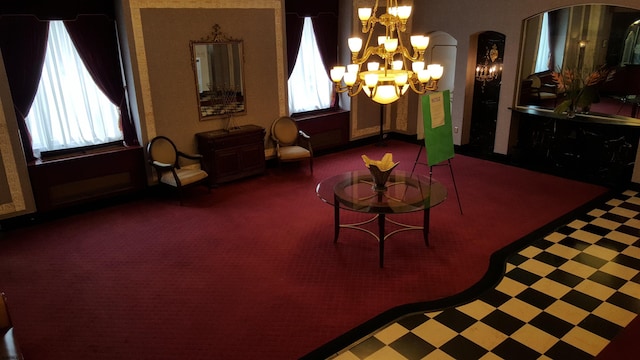 dining room with tile patterned floors, arched walkways, carpet flooring, and a notable chandelier