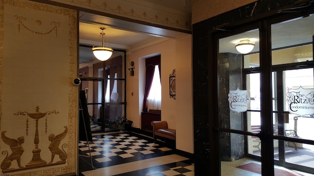 interior space featuring tile patterned floors and ornamental molding