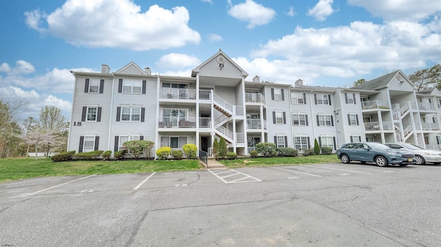 view of building exterior featuring uncovered parking
