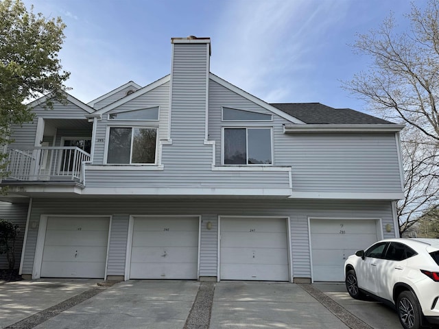 246 Heather Croft Unit 246, Egg Harbor Township, NJ 08234 - view of side of home featuring a chimney, a balcony, and a garage