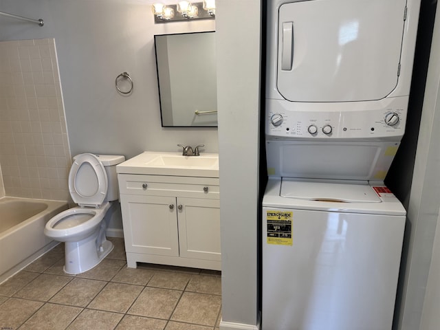 246 Heather Croft Unit 246, Egg Harbor Township, NJ 08234 - bathroom featuring stacked washer and clothes dryer, tile patterned floors, toilet, vanity, and baseboards