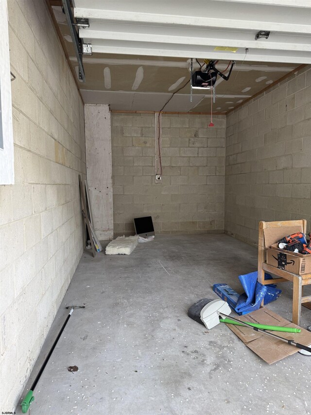 246 Heather Croft Unit 246, Egg Harbor Township, NJ 08234 - garage featuring a garage door opener and concrete block wall