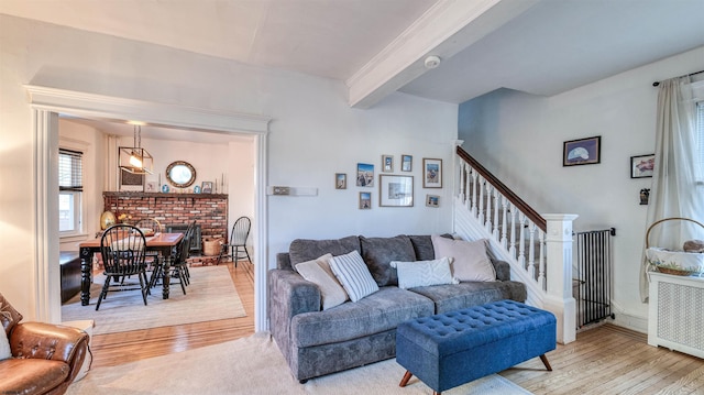 15 Elm Ave, Linwood, NJ 08221 - living room featuring radiator, light wood-type flooring, beamed ceiling, a brick fireplace, and stairs