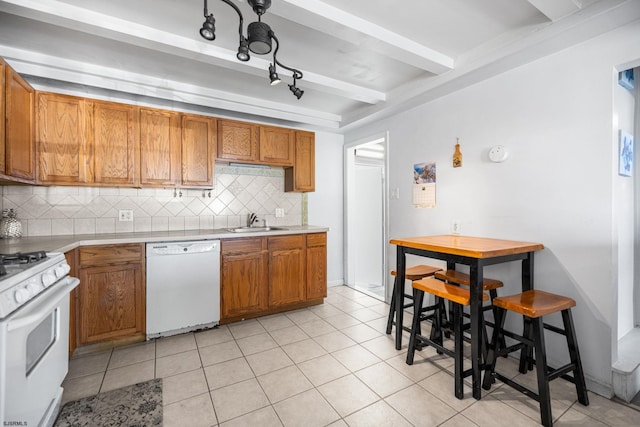 1139 Mcconnell Dr, Pleasantville, NJ 08232 - kitchen with a sink, tasteful backsplash, beamed ceiling, white appliances, and brown cabinets