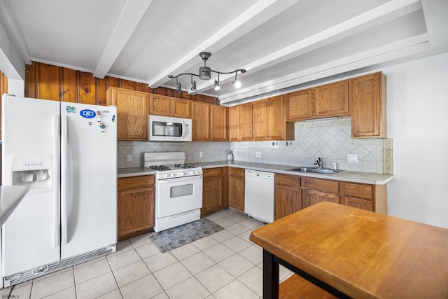 1139 Mcconnell Dr, Pleasantville, NJ 08232 - kitchen featuring backsplash, brown cabinetry, a sink, and white appliances