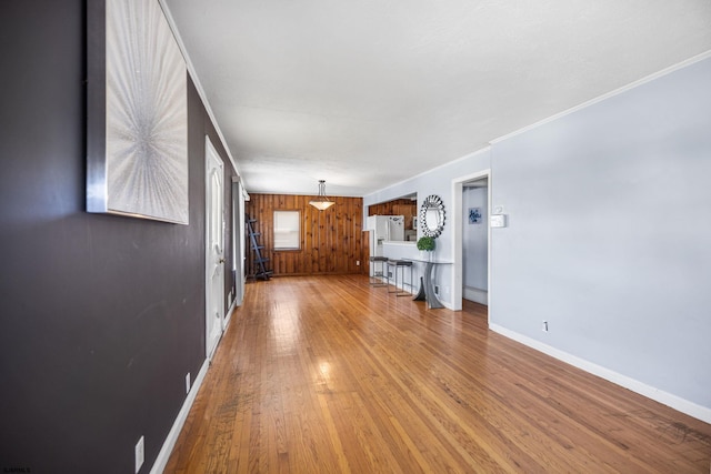 1139 Mcconnell Dr, Pleasantville, NJ 08232 - unfurnished living room with wooden walls, light wood-type flooring, baseboards, and ornamental molding
