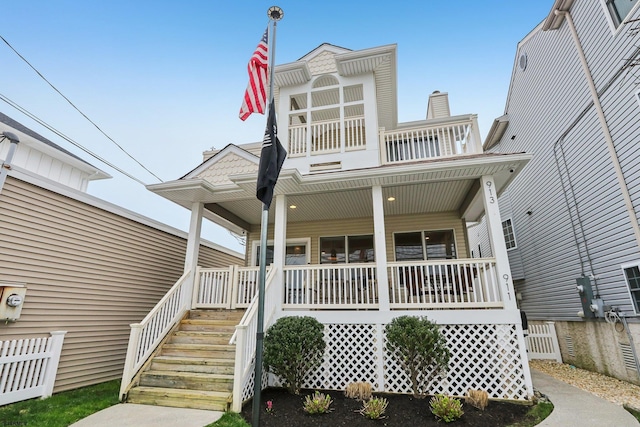 view of front of house featuring a porch and a balcony