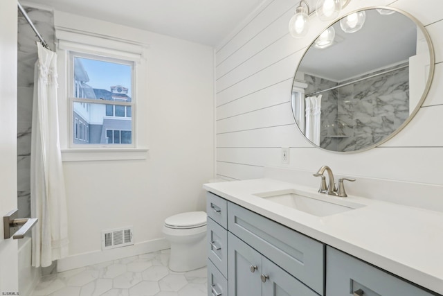 bathroom with vanity, wooden walls, baseboards, toilet, and visible vents