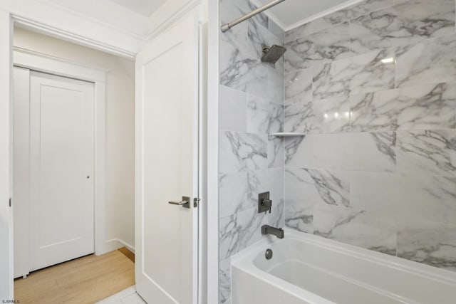 full bathroom featuring shower / bathtub combination, ornamental molding, and wood finished floors