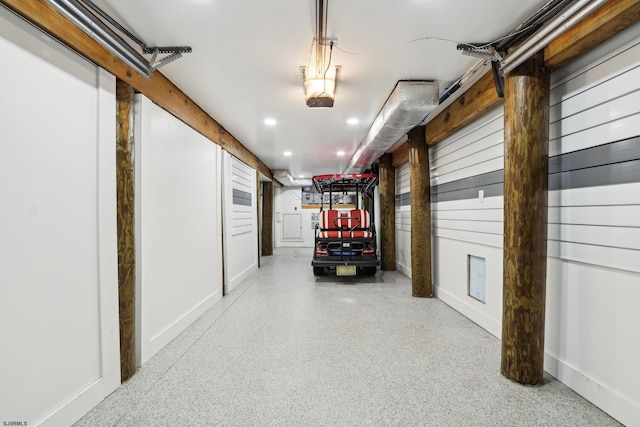 garage featuring baseboards and recessed lighting