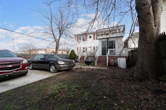 view of yard featuring a balcony and fence