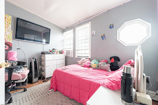 bedroom with wood finished floors and cooling unit