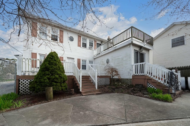 rear view of house featuring stairway and a balcony