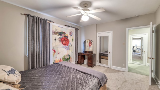 carpeted bedroom featuring baseboards and a ceiling fan