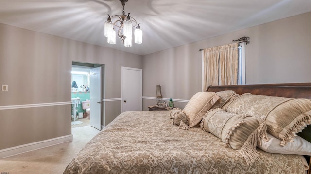 bedroom featuring connected bathroom, baseboards, and a chandelier