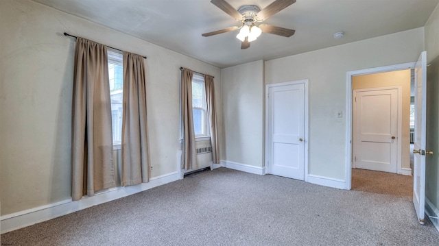 unfurnished bedroom featuring carpet flooring, baseboards, and ceiling fan