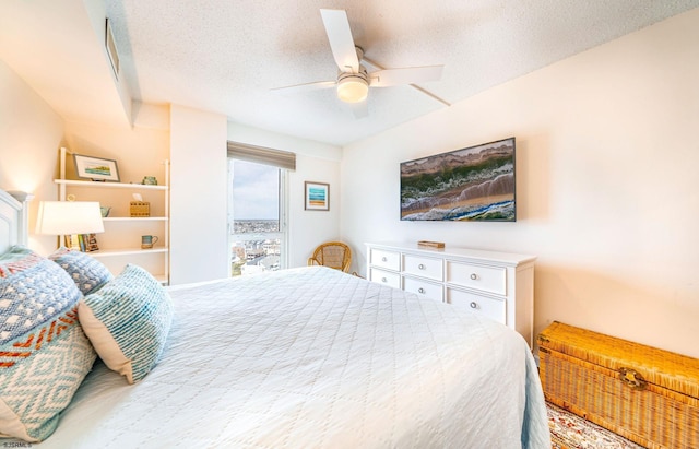 bedroom with a textured ceiling and a ceiling fan