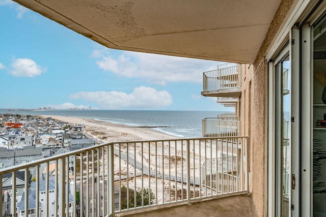 balcony with a beach view and a water view