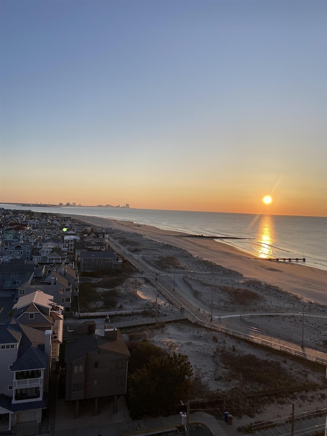 bird's eye view featuring a view of the beach and a water view