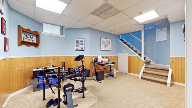 workout room with wainscoting and wooden walls